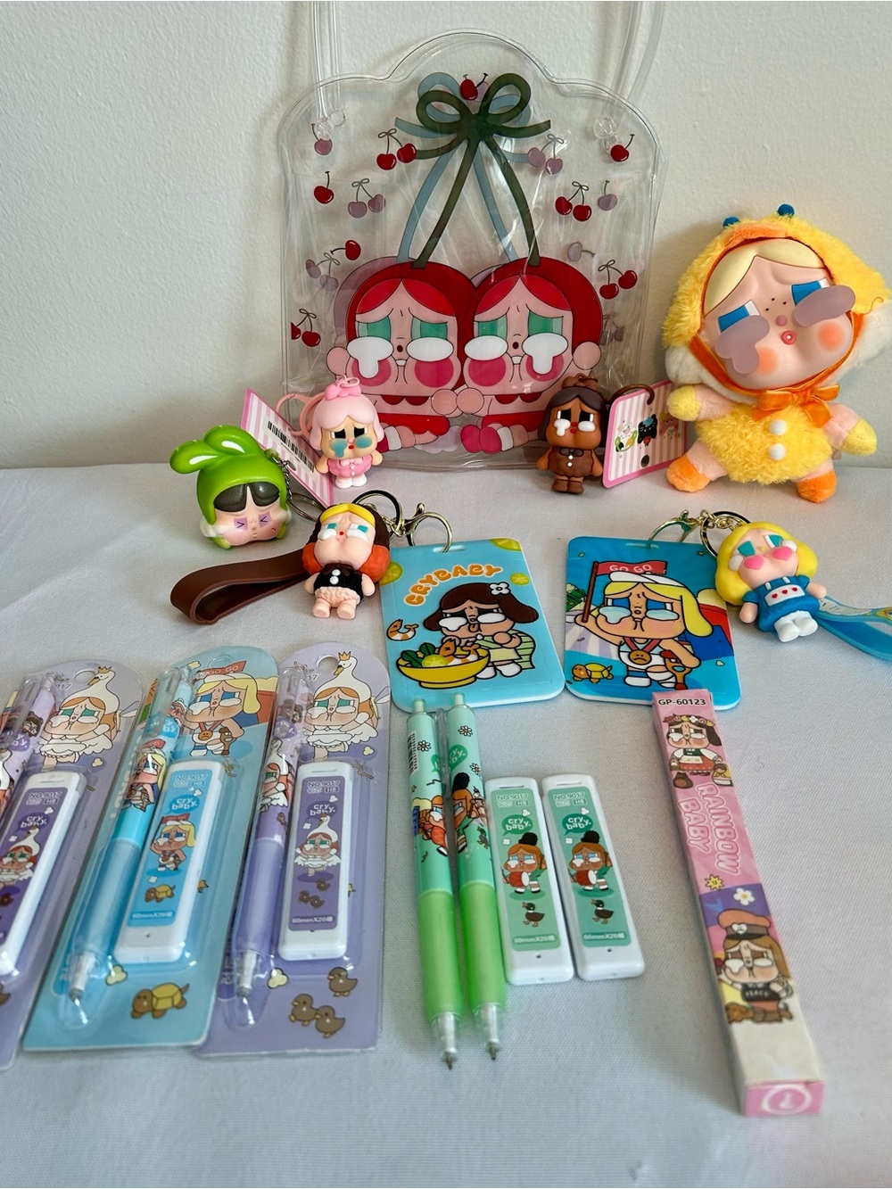 Crybaby plush, pens, pencils, ID badges and keychains
